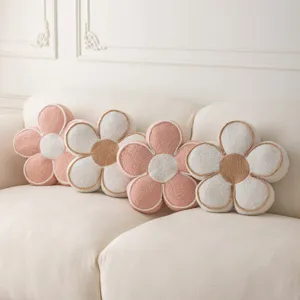 Detailed view of soft 3D flower plush pillows arranged nicely on a cozy white sofa decor.