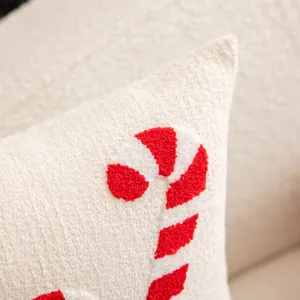 Christmas embroidered throw pillow cover detail, cozy plush fabric with candy cane design.