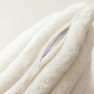Fluffy plush pillow cover detail showing soft texture and zipper closure for cozy home decor.