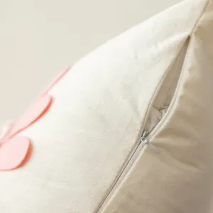Close-up of plush flower pillow cover, soft velvet fabric with hidden zipper, aesthetic decor.