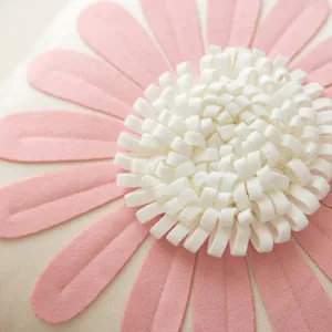 Pink flower cushion close-up showcasing detailed petal fabric and fluffy white center design.