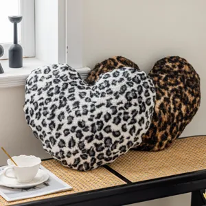 Leopard print heart throw pillow detail showing soft double-sided fleece material and plush texture.