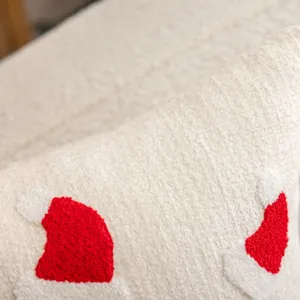 Close-up of Christmas embroidered pillow cover with soft plush fabric and cute hat patterns.