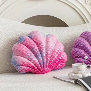 Close-up of pink mermaid scale seashell plush pillow detail, soft textured home sofa decor.