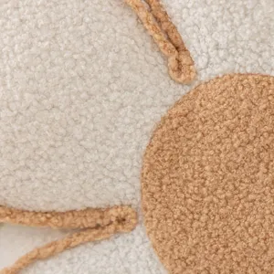 Close-up detail view of fluffy sherpa flower cushion texture, soft teddy fleece decorative pillow.