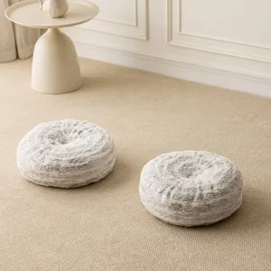 Detail view of round faux fur wheel throw pillow with silver tree ring texture for sofa.
