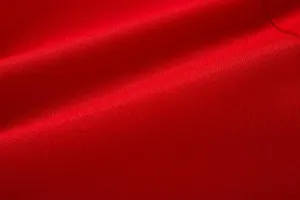 Red suit fabric texture detail, fine weave close-up shot showing quality material.