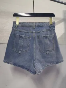 Denim shorts back view detail showing high waist design and dual back pockets craftsmanship.