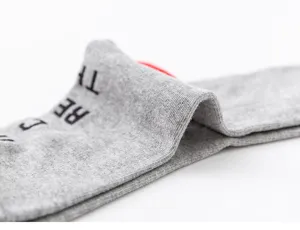 Close-up detail of winter extra-large long cotton socks showing soft grey knit texture.