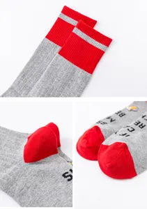 Men's winter long cotton socks detail view, red and grey color block design with novelty text.