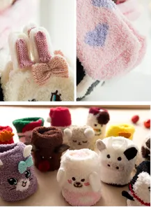 Close-up detail showing soft plush fleece texture and cute cartoon animal designs on socks.