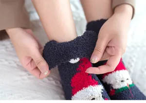 Cozy plush fuzzy Christmas socks detail shot, soft warm winter thermal sleep floor socks.