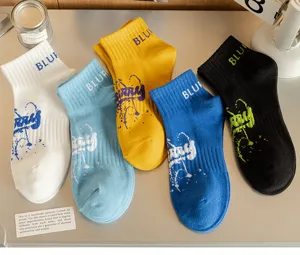 Detail view of trendy men short socks with colorful blur print and comfortable cotton fabric.