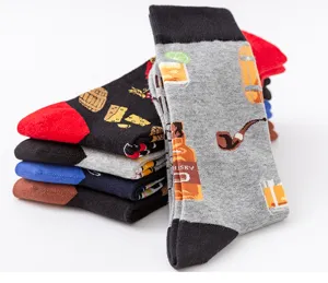 Close-up detail of patterned men's mid-calf cotton socks stacked neatly on white background.