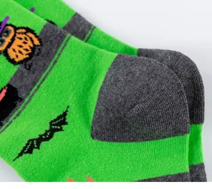 Men's Halloween knit socks detail shot showing green and grey stripes with owl and bat motifs.