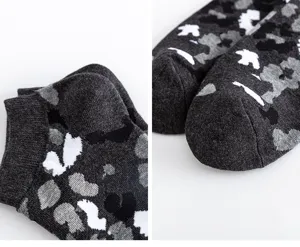 Detailed close-up view of men's short ankle socks in dark grey pattern, pure cotton.