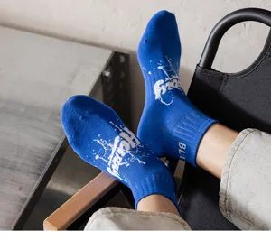 Men's blue short sports socks with stylish graffiti splatter print and ankle stripe details for casual wear