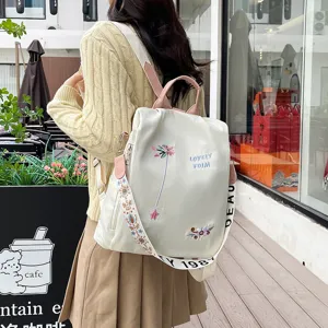 Chic women casual backpack stylish daily commuter school bag with embroidered floral design.