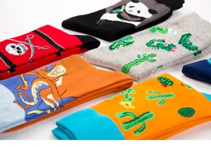 Close-up details of cartoon printed cotton crew socks featuring cute panda and cactus patterns.
