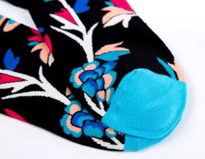 Detailed view of colorful floral pattern long socks with blue heel accent, soft cotton fabric.