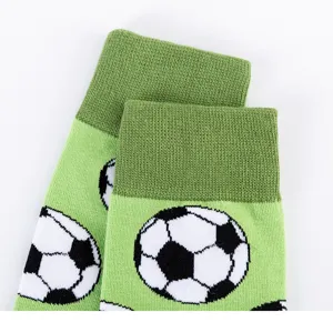 Detail shot of green men's crew socks featuring a fun soccer ball pattern and ribbed cuffs.