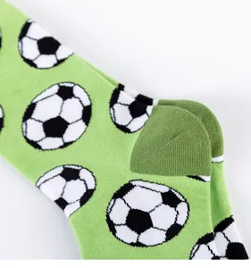 Men green soccer pattern long cotton socks detail view showing knit heel and football print.