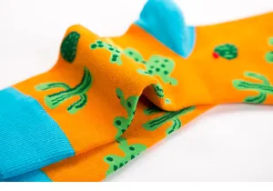 Colorful cactus print long cotton socks, vibrant orange with blue heel, casual street style.