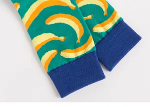 Detail view of men's trendy long socks with banana print and blue cuffs. Perfect for daily wear.