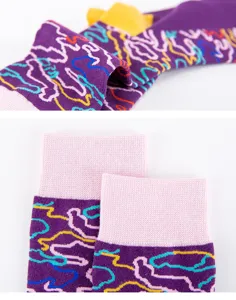 Detailed view of colorful abstract pattern men cotton socks with pink ribbed cuffs close up.