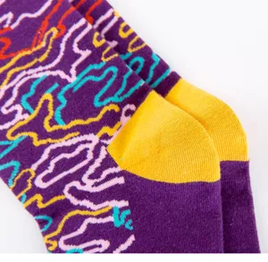 Men's colorful patterned long cotton socks with stylish abstract lines and vibrant yellow heels.