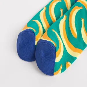 Men green banana print skate socks detail shot showing blue toe design and soft fabric.