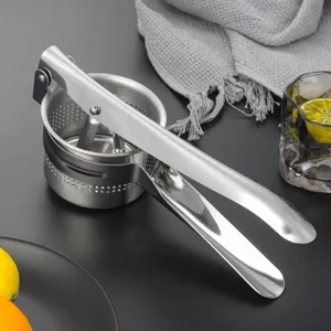 Stainless steel manual potato ricer and fruit juicer for home kitchen cooking use.