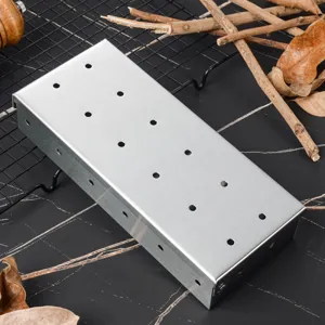 Stainless steel BBQ smoker box with ventilation holes for outdoor charcoal gas grill.