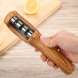 Detail view of a portable wooden texture kitchen knife sharpener with metal rolling wheels.