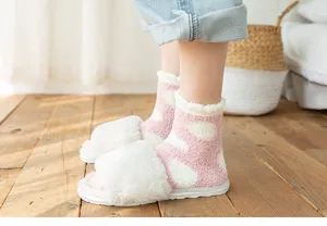 Soft coral fleece fuzzy socks with cute polka dot pattern, cozy sleep socks detail view.