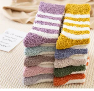 Detailed close up view of soft coral fleece striped socks neatly stacked for indoor wear.
