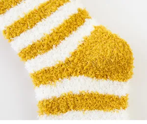 Close-up detail of soft coral fleece striped fuzzy socks for cozy home and sleep wear.