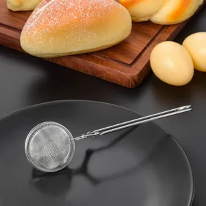 Stainless steel tea strainer detail close up wire handle kitchen tool for loose leaf tea.