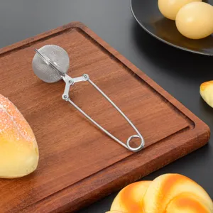 Stainless steel tea infuser ball with wire handle kitchen tool scene detail shot