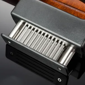 Detailed view of 48 needle meat tenderizer with stainless steel blades for kitchen cooking.