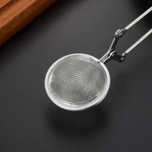 Stainless steel tea strainer mesh ball detail view with scissor handle for loose leaf tea.
