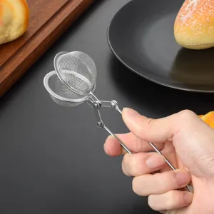 Stainless steel tea infuser detail view showing mesh ball structure and long handle.