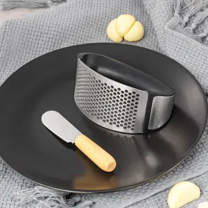 Stainless steel curved garlic press rocker set with wooden handle for kitchen cooking tools.