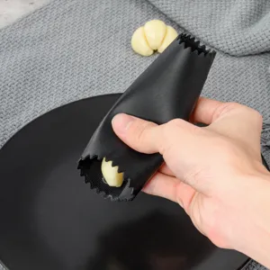 Silicone garlic peeler detail view, showing the flexible black tube and textured interior.