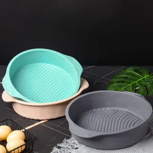 Detailed shot of round silicone cake baking mold with comfortable handles for kitchen.