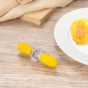 Close-up detail of portable yellow corn peeler and kernel remover kitchen cooking tool.