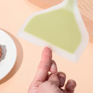 Detail shot of the dual-color silicone spatula, wide design for cooking pancakes.
