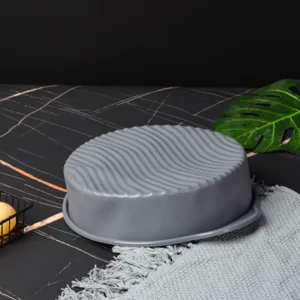 Detailed view of the 9-inch round grey silicone cake mold with non-stick wavy surface texture.