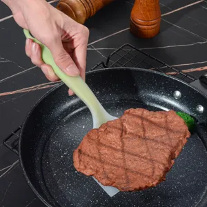 Ergonomic two-tone silicone spatula wide cooking turner for steak, pancakes, and eggs.