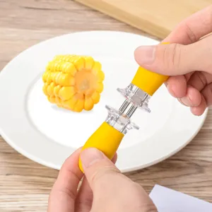 Stainless steel corn holder with yellow handle, portable BBQ fork detail view in kitchen